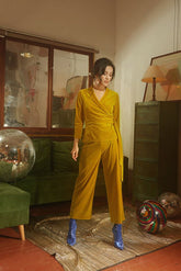 Wrap-style velvet blouse with structured waist and full-length sleeves for tailored elegance